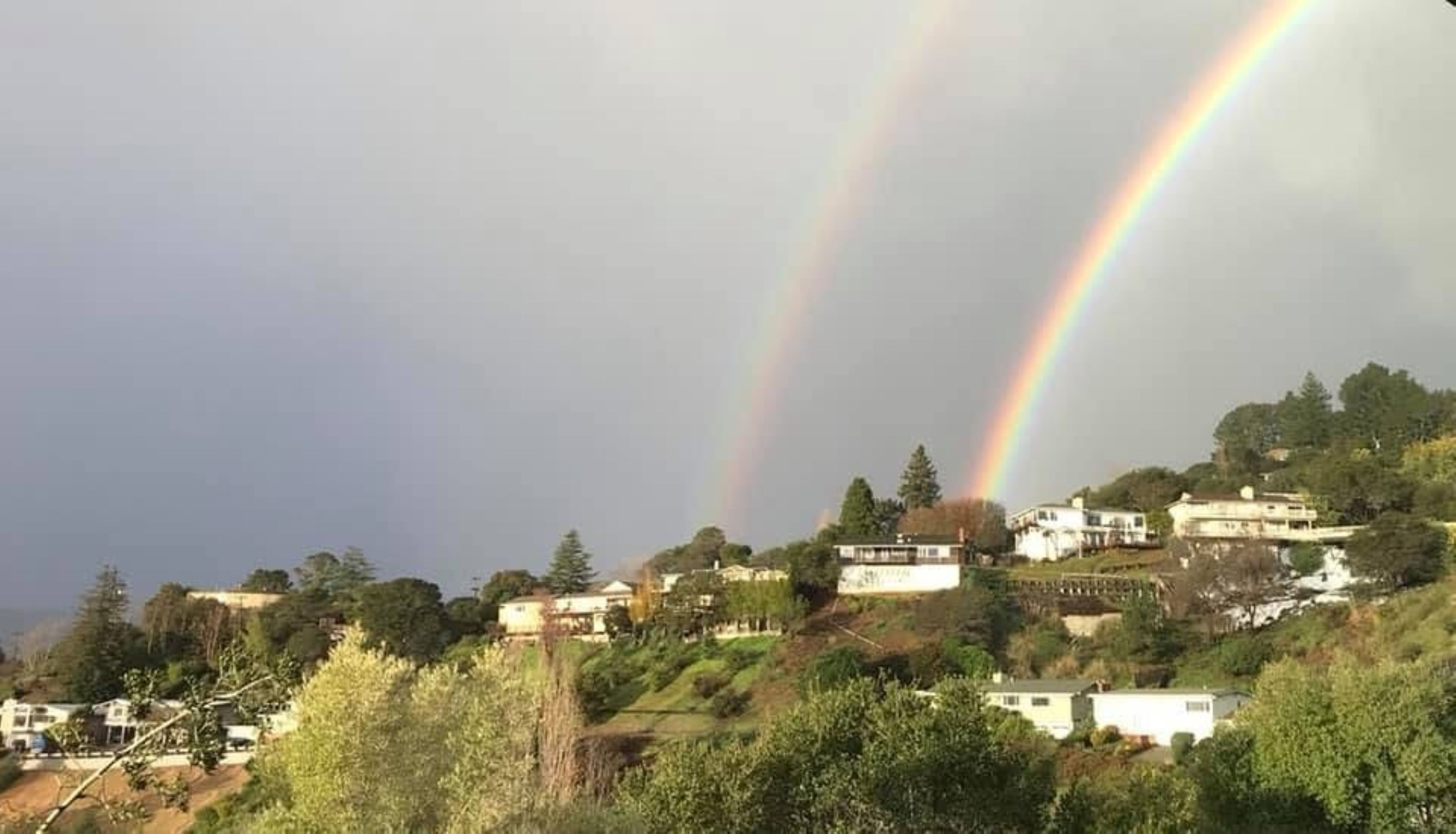 Double rainbow over the hillside
